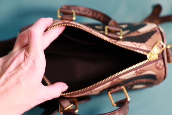 A person holding an open purse with one hand.