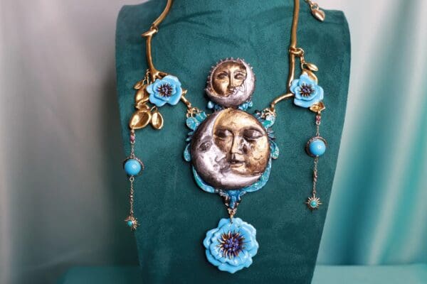 A necklace with faces and flowers on it