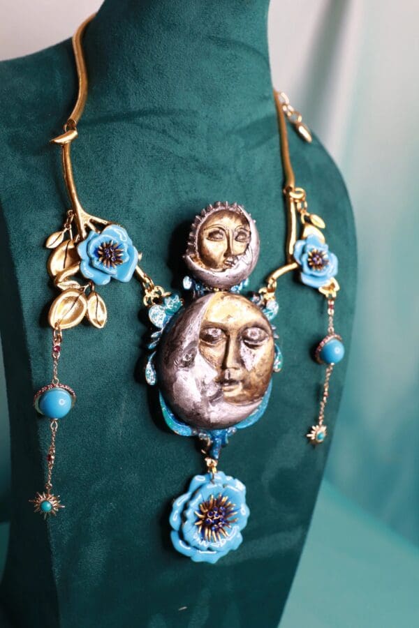 A necklace with faces and flowers on it