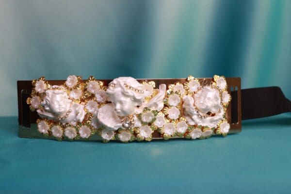 A close up of a bracelet with flowers on it