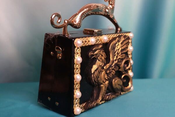 A black purse with a dragon on it