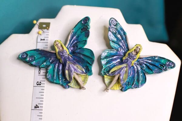 A pair of blue and purple butterflies with yellow wings.
