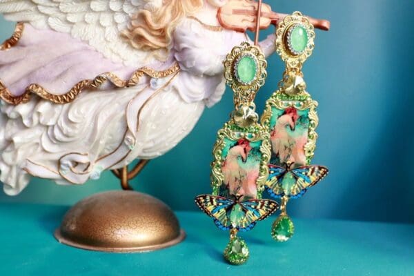 A statue of a woman and a pair of earrings.