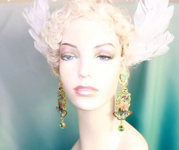A mannequin wearing earrings and a white wig.