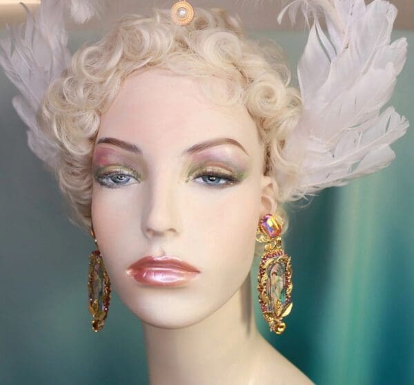 A mannequin with white feathers on her head.