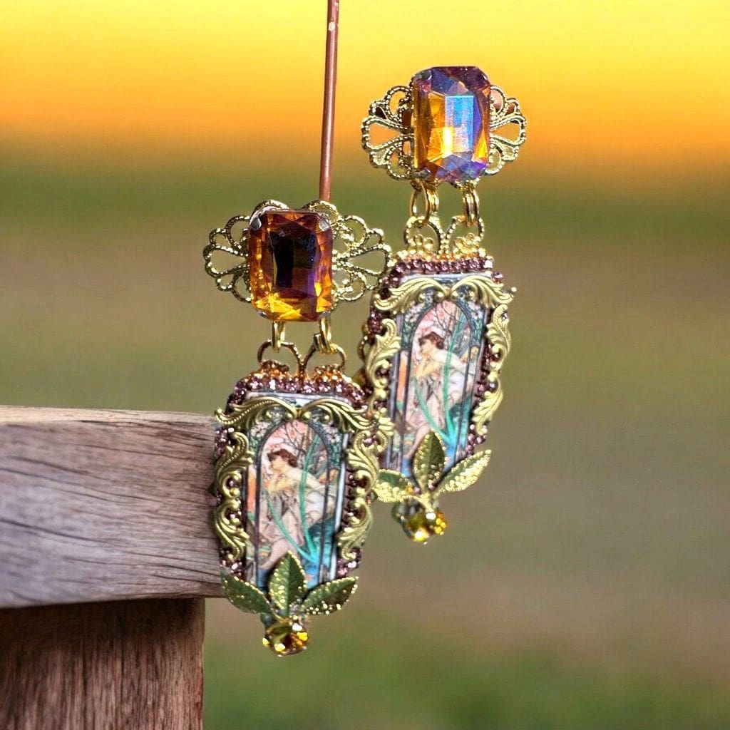 A pair of earrings hanging from a wooden post.