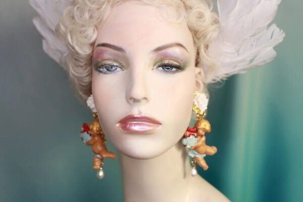 A mannequin with long earrings and a white wig.