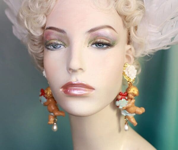 A mannequin wearing earrings with teddy bears on them.