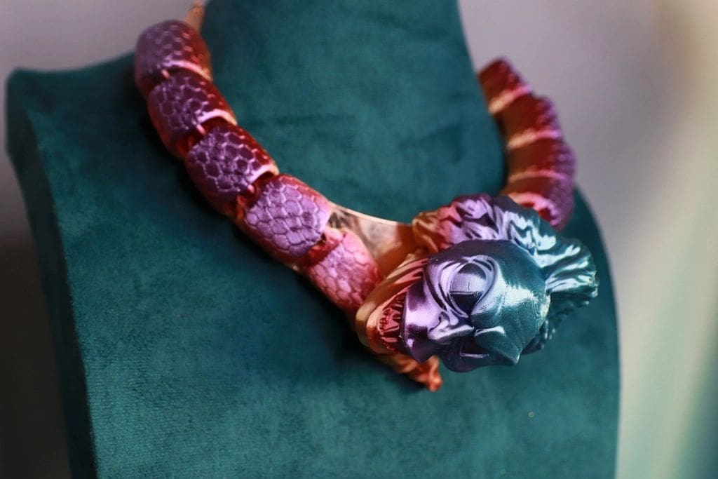A snake like necklace with a dragon head on it.