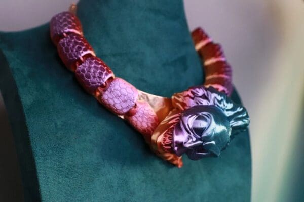 A necklace with a dragon head on it.