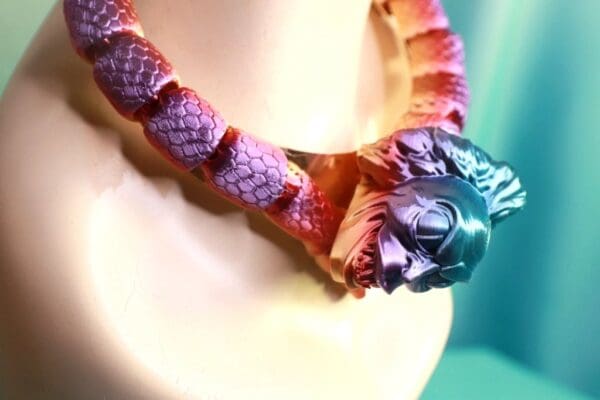 A close up of the necklace on a cake