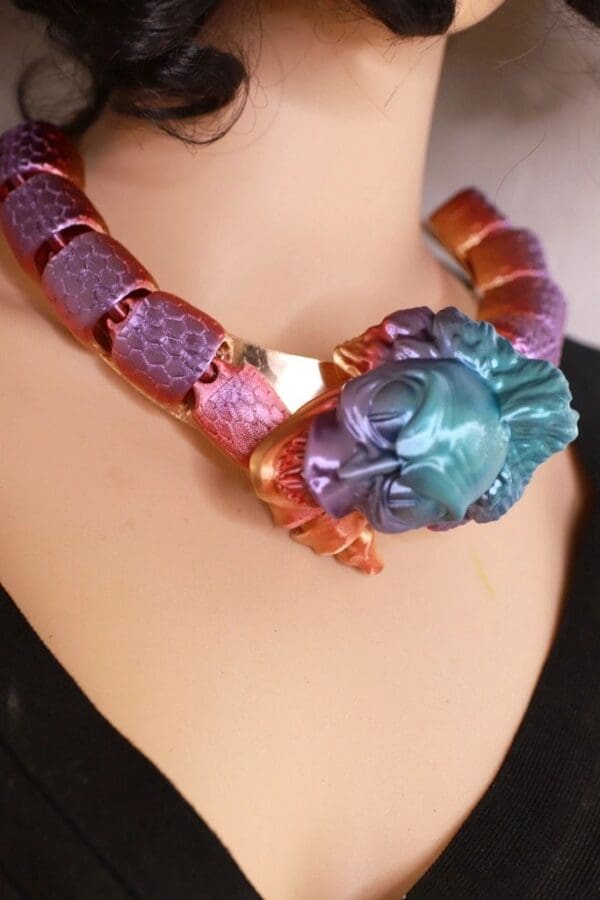 A woman wearing a necklace with a colorful design.