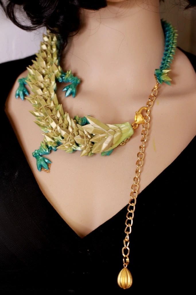 A woman wearing a necklace with leaves on it.