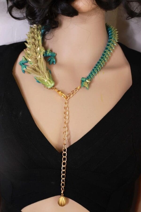 A woman wearing a necklace with green and gold chains.