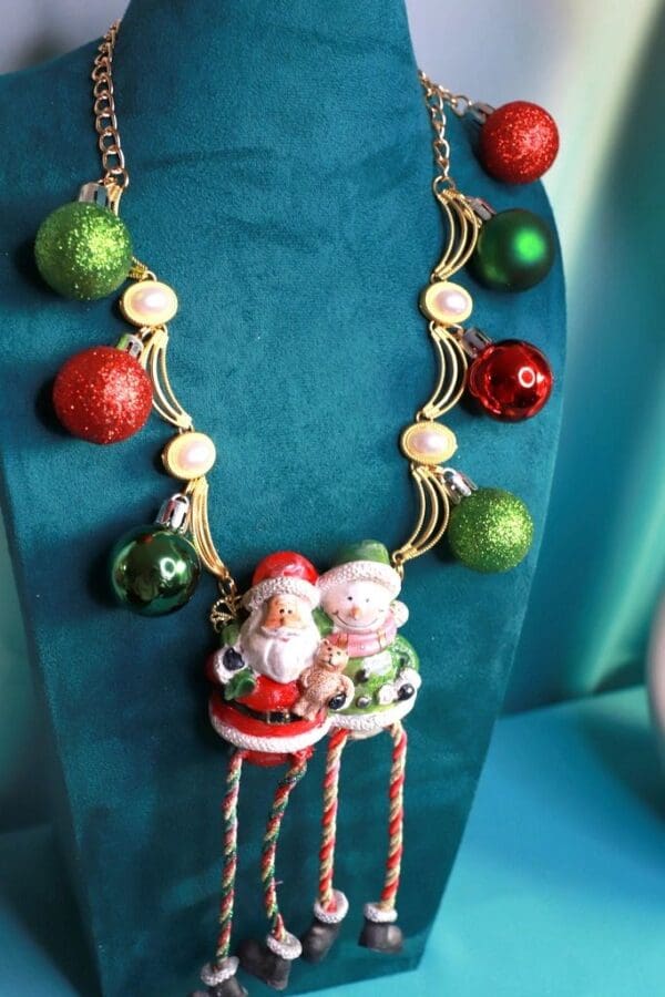 A necklace with santa clause and christmas ornaments.