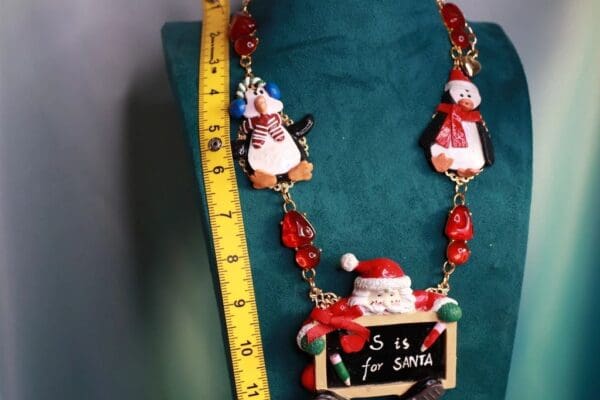 A necklace with santa and penguins on it