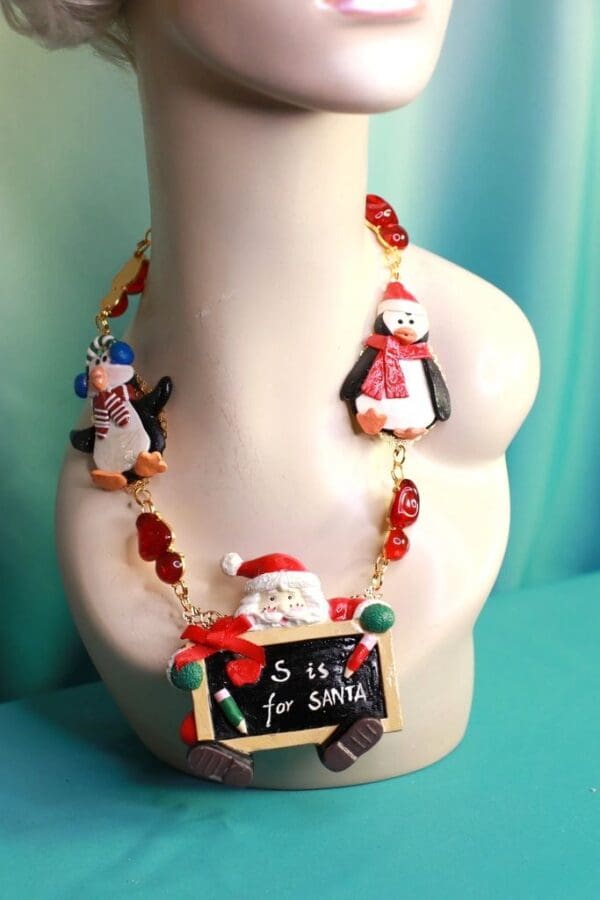 A necklace with santa and penguins on it.