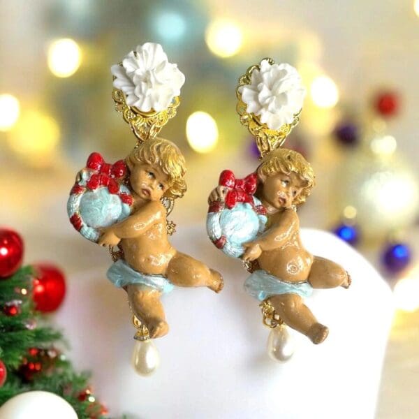 A pair of earrings that are on top of a cake.