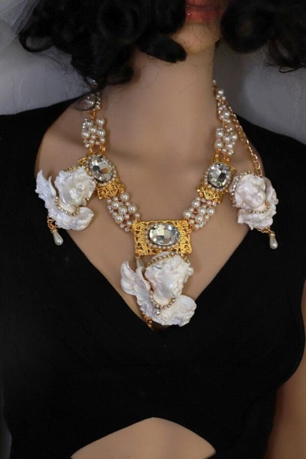 A woman wearing a necklace with white flowers.