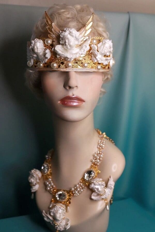 A mannequin wearing a crown and necklace.