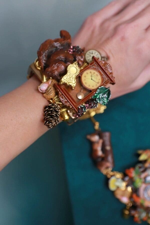 A woman 's arm with a bracelet and some food on it