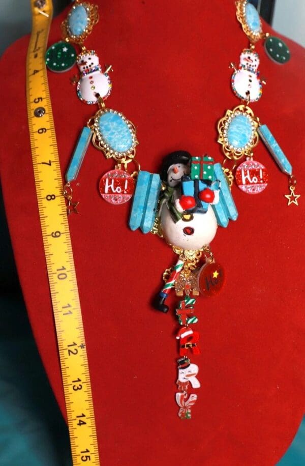 A red wall with a large necklace and some blue beads