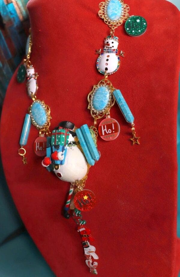 A necklace with a snowman and other decorations.