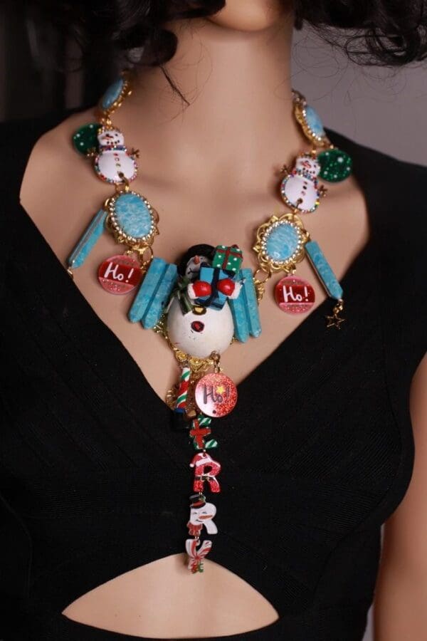 A woman wearing a necklace with various shapes and colors.