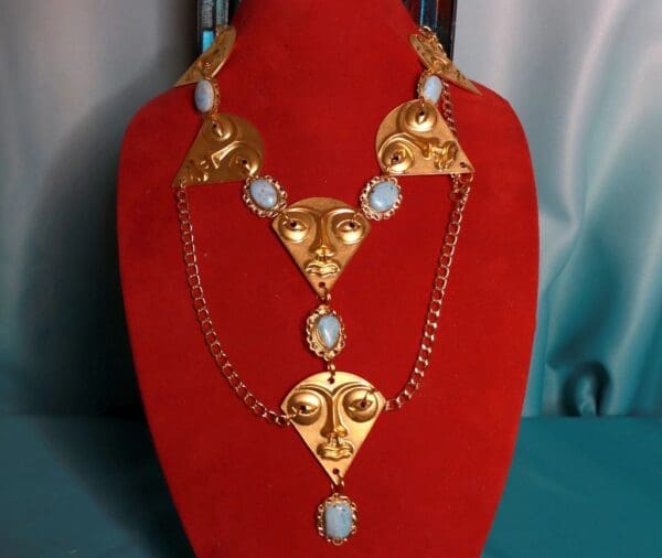 A red display stand with a necklace and earrings on it