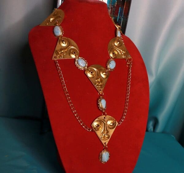 A red display stand with a necklace on it
