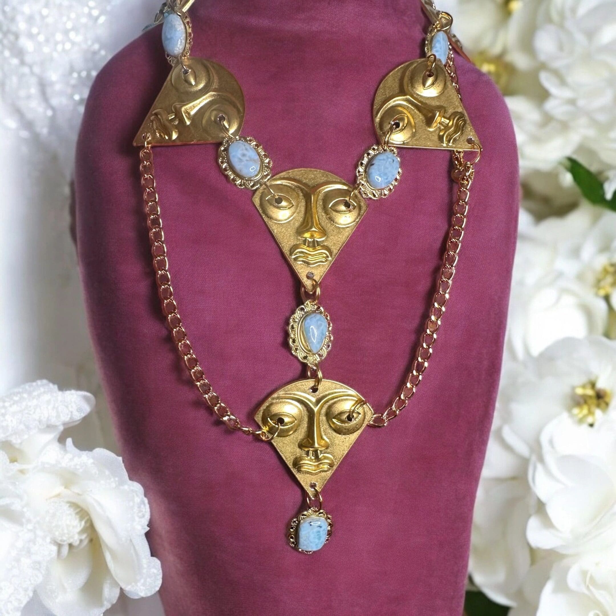 A necklace with gold and blue stones on it