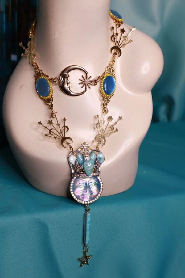 A white mannequin with a blue necklace and a clock.