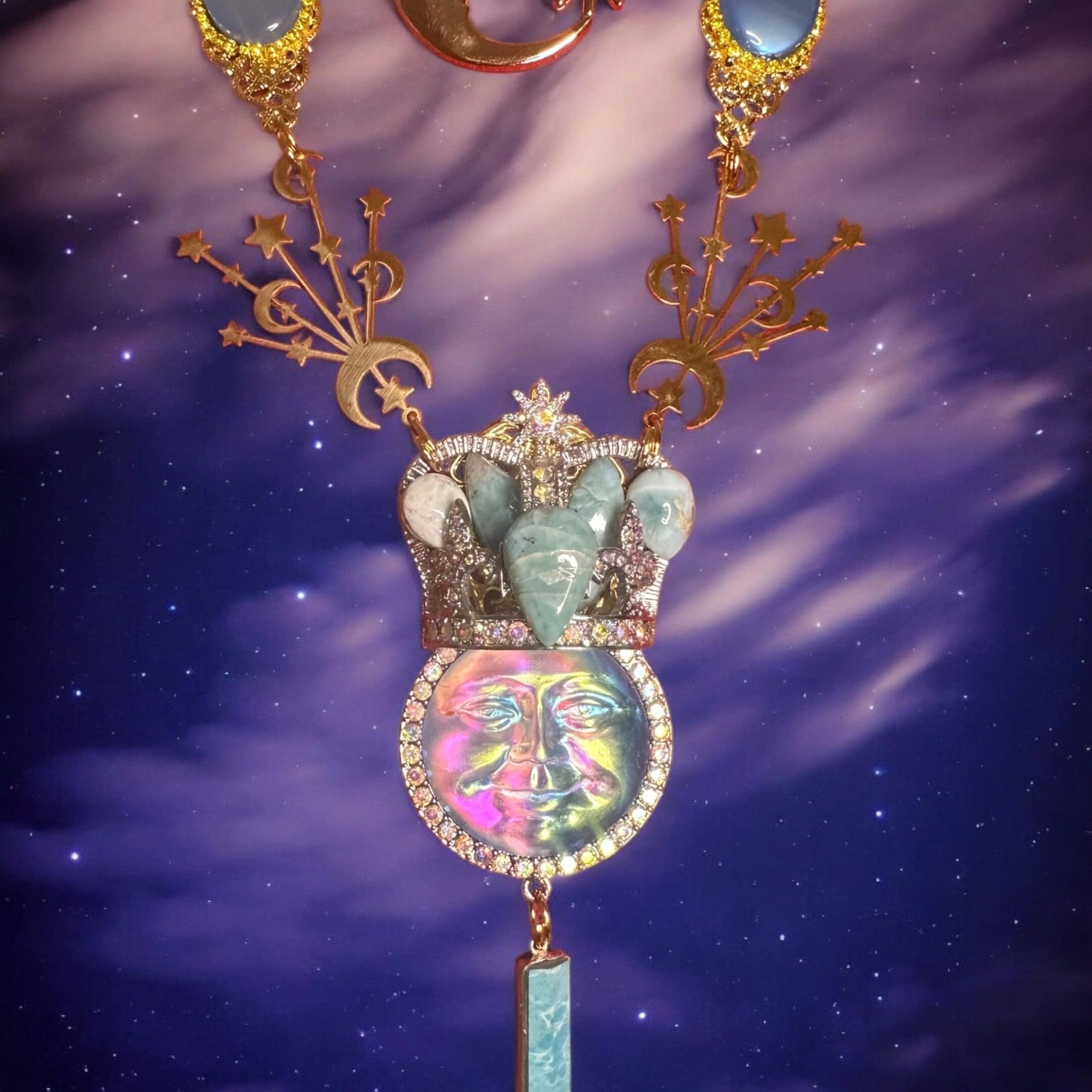 A necklace with an elephant and a crown on it.
