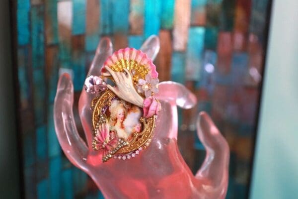 A hand holding something with a shell on it
