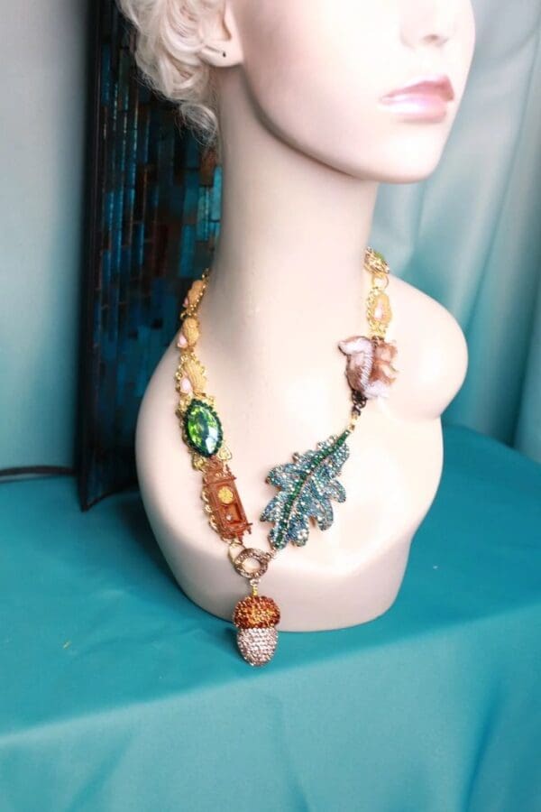 A white mannequin head wearing a necklace with various charms.