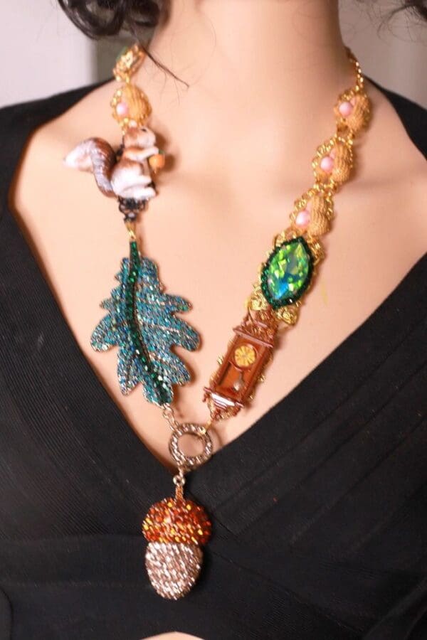 A woman wearing a necklace with various items on it.