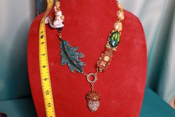 A red display with a necklace and measuring tape.