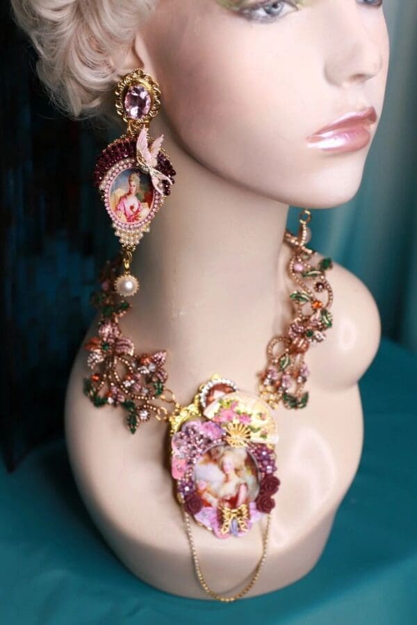 A woman wearing a necklace and earrings with pink flowers.