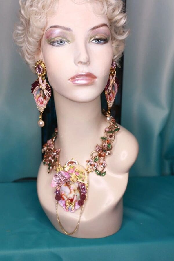 A mannequin wearing a necklace and earrings.