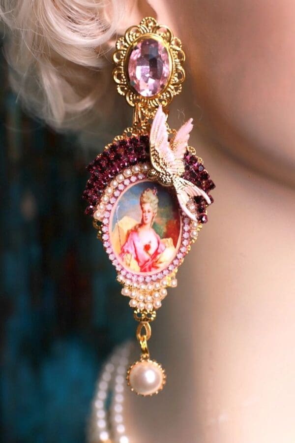 A woman wearing a necklace with a picture of jesus.