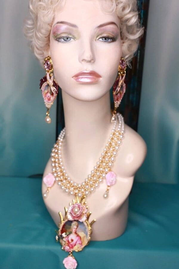 A mannequin wearing jewelry and earrings.
