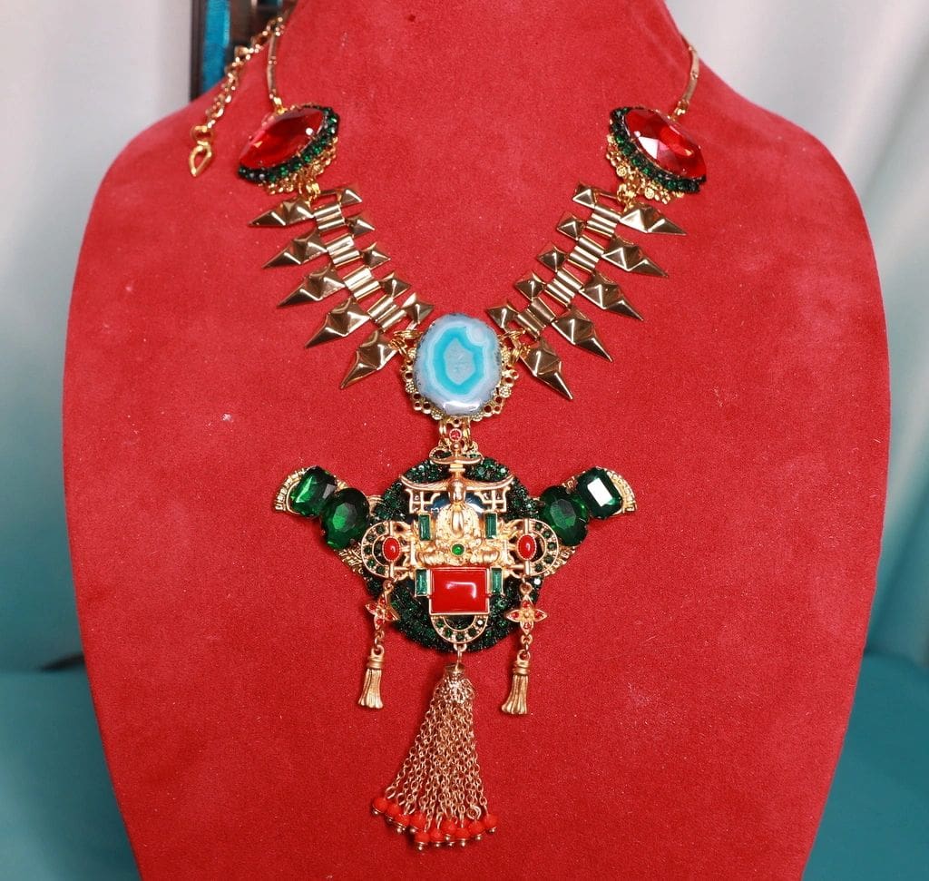 A red display stand with a necklace on it