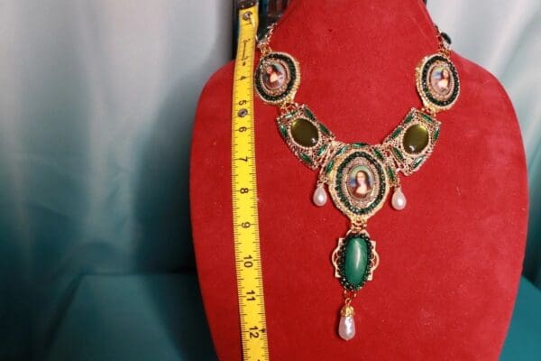 A red velvet display with a necklace and measuring tape.