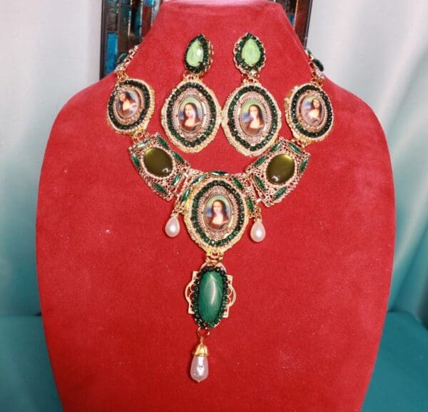 A red velvet display with a necklace and earrings.