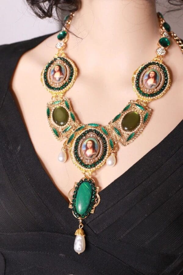 A woman wearing a necklace with green stones.