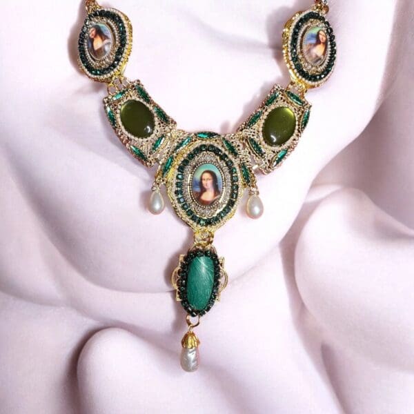 A necklace with green stones and gold accents.