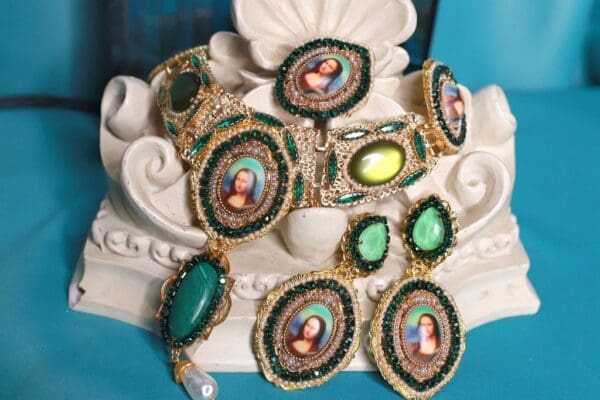 A set of jewelry with paintings on them.