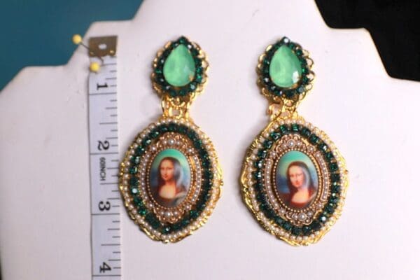A pair of earrings with a picture on them