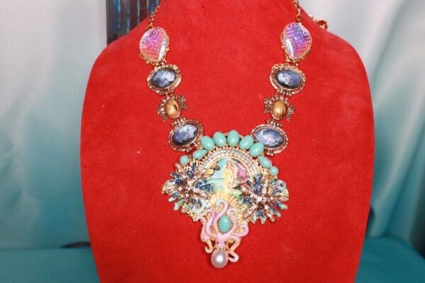 A red velvet display with a necklace on it