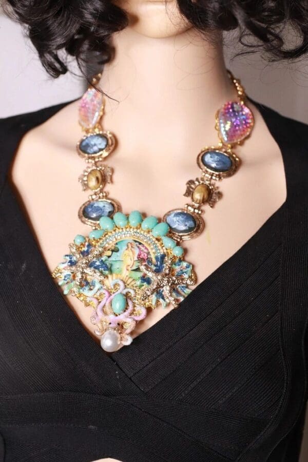 A woman wearing a necklace with many different colored stones.
